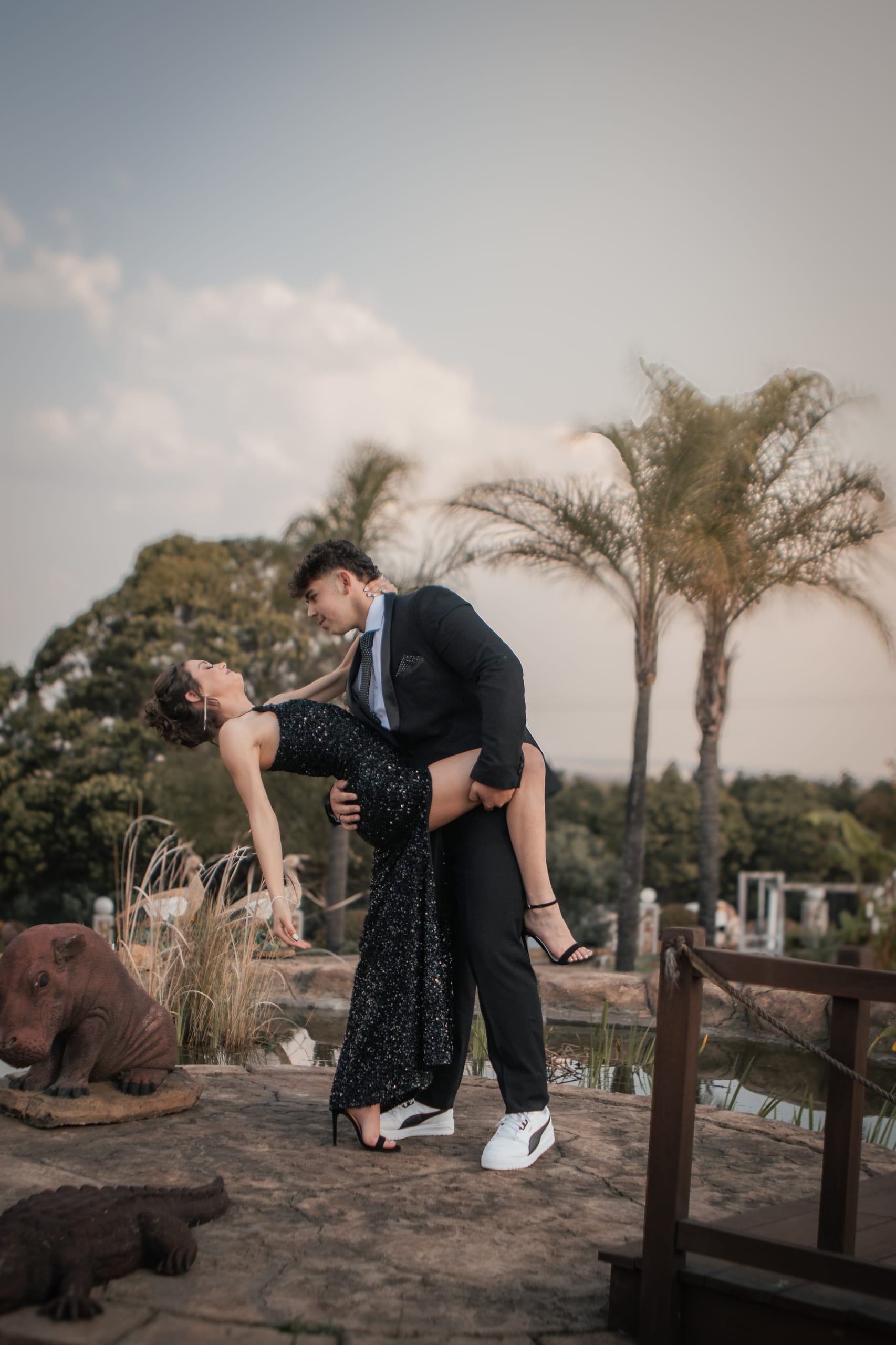 Matric farewell couple laughing during a playful dip outdoors
