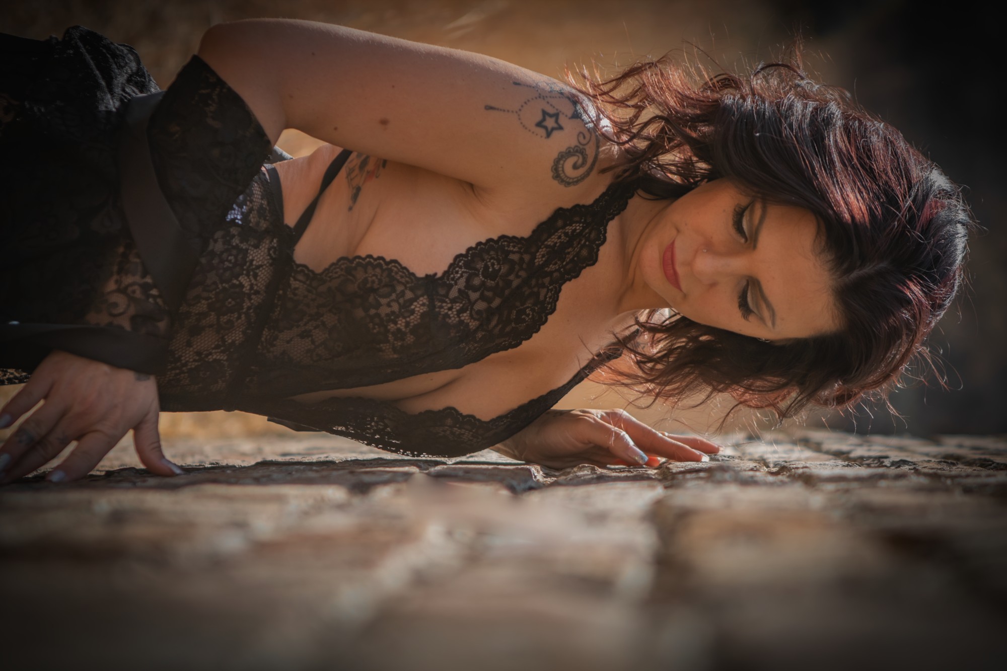 Close portrait in black lace against a wall outdoors