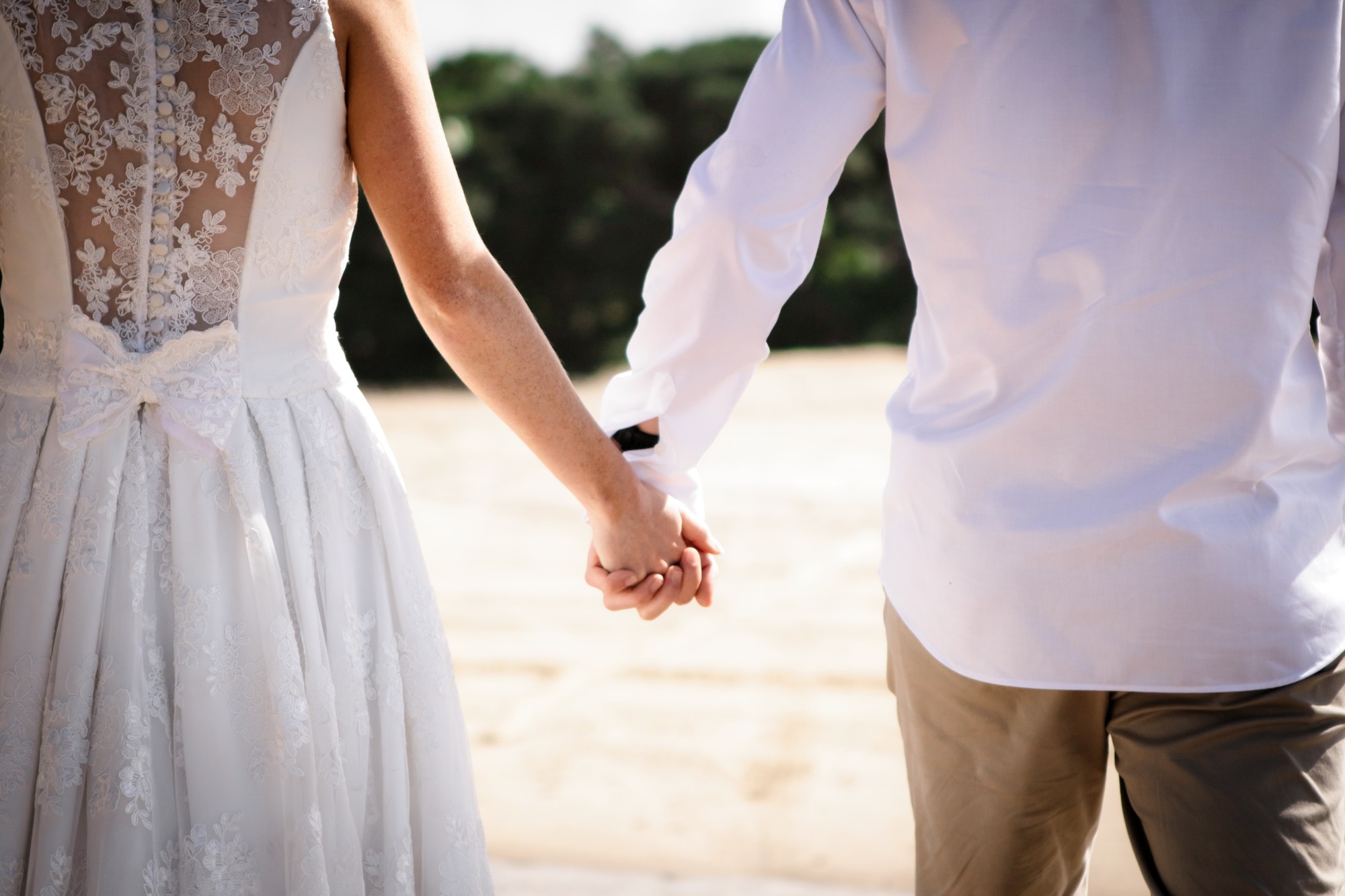 Wedding couple holding hand detail